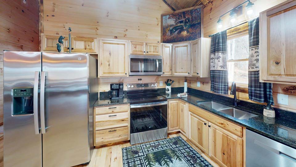 WILDLIFE ESCAPES CABIN Exterior evening shot of Twilight Ridge Cabins with warm glowing lights.