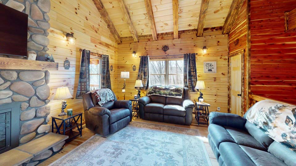 WILDLIFE ESCAPES CABIN Modern rustic cabin exterior with large windows reflecting tall Ohio timber.